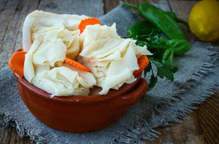 Raw Tripe with Vegetables and Seasoning: Carrots, Peppers, Parsley, Basil in Rustic Ceramic Bowl on a Wooden Backgroundの写真素材
