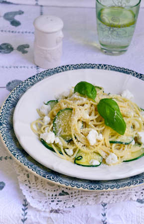Vegetarian Pasta Spaghetti with Zucchini and Ricotta cheese served on a white plate. Italian food, recipes. Mediterranean Kitchen. Top view.の写真素材