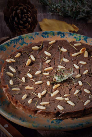 Typical Italian Sweet Chestnut Cake (Tuscan Chestnut) on a wooden background. Traditional Italian recipes. Close-up, Dark Toned Image, Rural Food Styleの写真素材