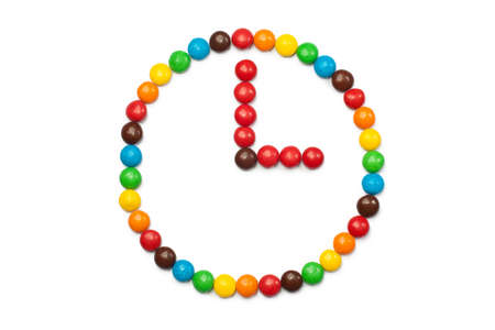 stylized watch from colored glazed candies isolated on white background. Icon of time,  waiting,...