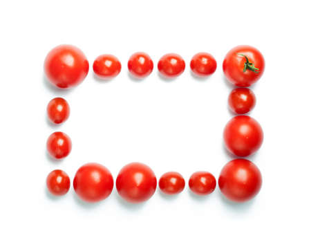 The rectangular frame of cherry tomatoes isolated on a white background. Unusual place for text about cooking, nutrition, healthy lifestyles, Italian food, organic food, etc.の写真素材