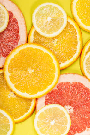 Juicy citrus on a yellow background. Bright vitamin photo. Place for your text