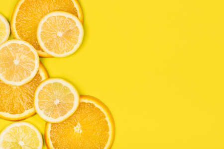 Juicy citrus on a yellow background. Bright vitamin photo. Place for your textの写真素材