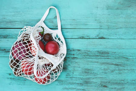 Vegetables in eco bag on a vintage wooden backgroundの写真素材
