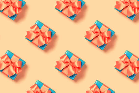 Pattern with stylish gift on a trendy coral background. Present for St. Valentines day, engagements, Mothers Day, birthday, New Year, Christmas, holidaysの写真素材