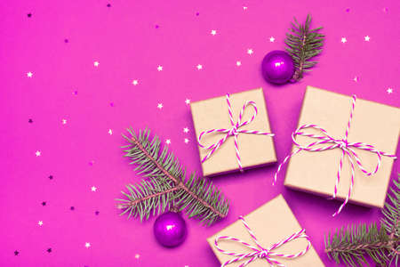 Christmas composition with gifts, branches and holiday elements on the violet background. Flat lay. Merry Christmas, New Year, winter concept.の写真素材