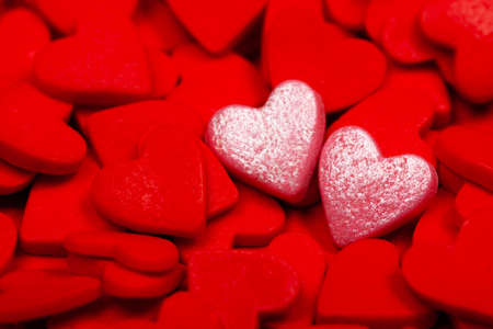 Two sweet loving hearts among many red hearts. The concept of St. Valentines Day, love, couple,...