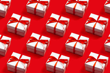Pattern of trendy attractive minimalistic gifts on the red background. Merry Christmas, St. Valentines Day, Happy Birthday and other holidays concept.の写真素材