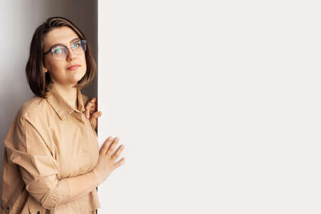Portrait of stylish intellectual credible woman with white place for information. Nice smile, glasses. The concept of a doctor, psychologist, psychiatrist, blogger, designer.の写真素材