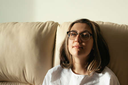 Portrait of young woman at home. The concept of natural beauty, femininity, feminism, body positive.の写真素材