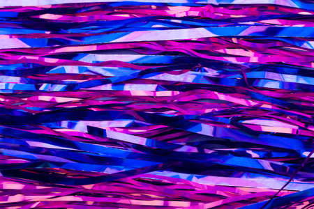Abstract neon pink and blue background. New Years tinsel. Active lines.