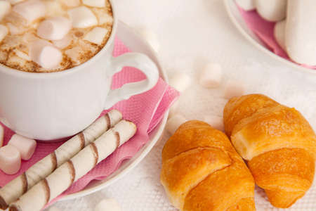 cup of coffe with marshmallow and croissantsの写真素材