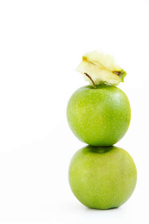 Green apple on the apple and on top of them the stub from Apple on the white backgroundの写真素材