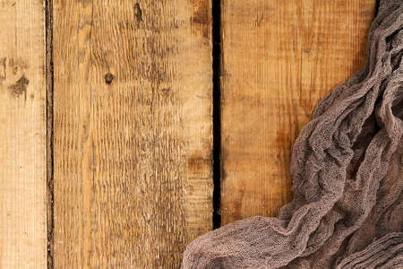 old natural wood plank decorated on the edges of the background texture gauze gray fabricの写真素材