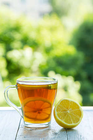 summer cold cup of tea on a wooden tableの写真素材
