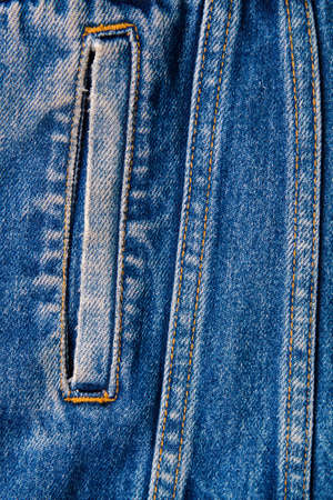 part of blue worn denim jeans close-up, background