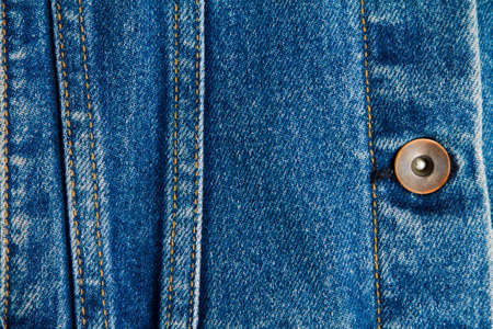 part of blue worn denim jeans close-up, background