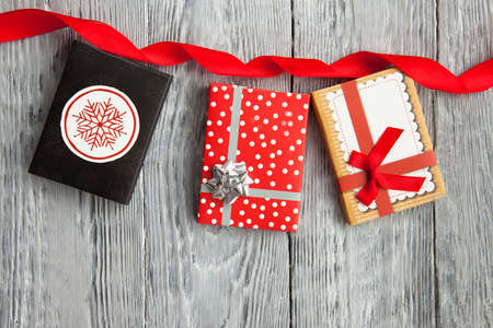 three gifts in colorful boxes with bow for holiday, in wooden background