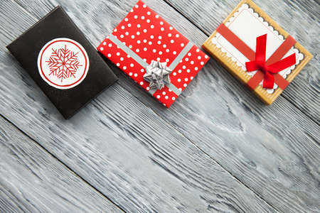 gifts in colorful boxes with bow for holiday, in a iwooden background