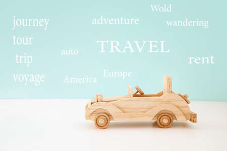 wooden vintage toy car on a blue and wooden background.Concept travelの写真素材