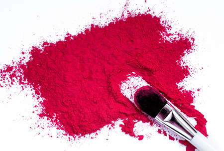 makeup brush and scattered blush on a white backgroundの写真素材