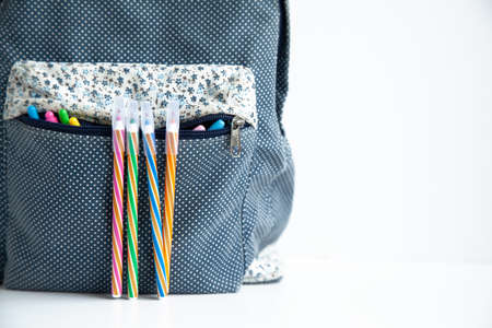 School bag with colored pens on the white backgroundの写真素材