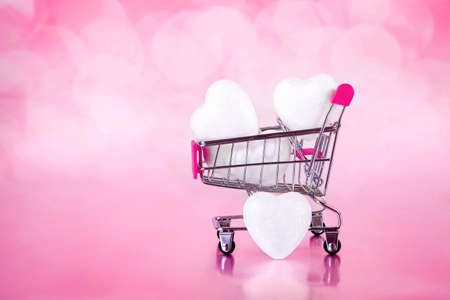 shopping cart with white little hearts on pink with bokeh backgrounds