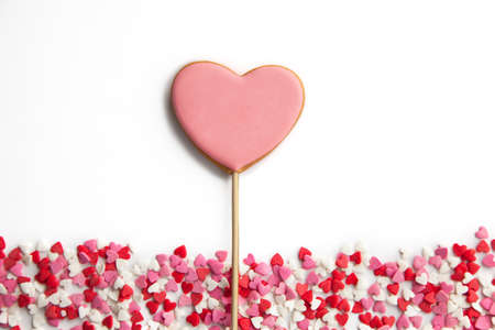 One sweet heart on a stick and lots of little hearts on white