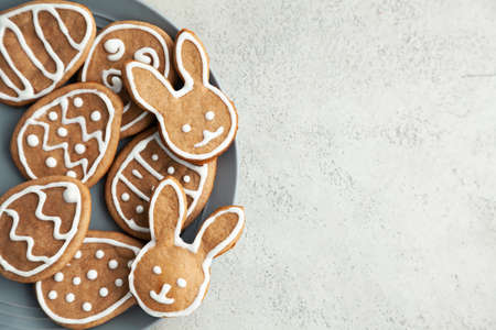 Easter cookies on a grey plate on a stone background. Easter bunnies. Copy space and top view.の写真素材