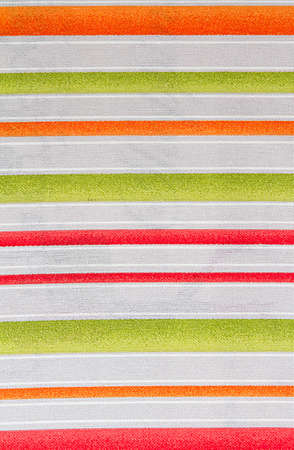 White and orange, green striped fabric. Fabric texture, abstract background for design.の写真素材