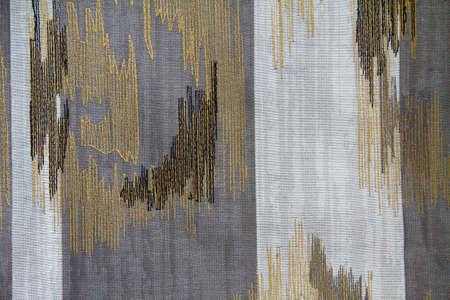 Abstract fabric pattern with embroidery on gray and white fabric. Background texture is a sample for the design.の写真素材