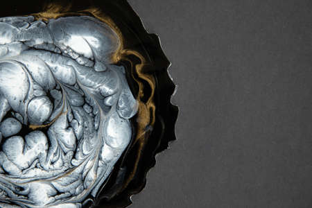 Abstract painting with epoxy resin. Marble circles in black, white and gold colors.の写真素材