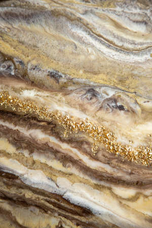 Abstract painting with epoxy resin. Marble streaks of gold,brown and beige . Abstract modern with streaks liquid background for design.の写真素材