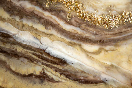 Abstract painting with epoxy resin. Marble streaks of gold,brown and beige . Abstract modern with streaks liquid background for design.の写真素材