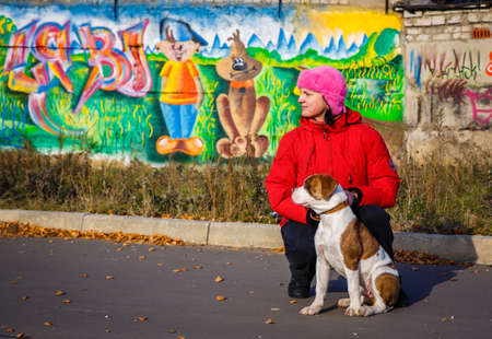 woman walking and American Bulldog puppyのeditorial素材