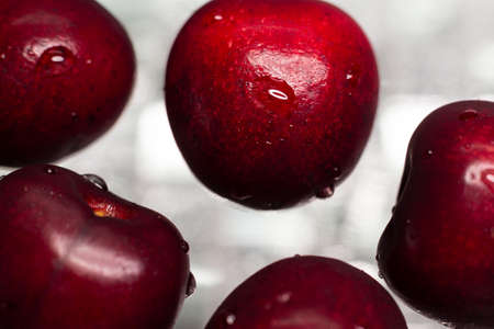 Macro photo of a red, ripe, fresh cherry with water drops. Texture, backgroundの写真素材