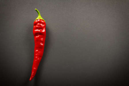 Red chilli peppers close up on a black background