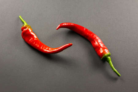 Red pepper two pieces on a dark backgroundの写真素材