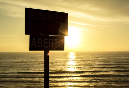 Sunset on the ocean, and the signpostの写真素材
