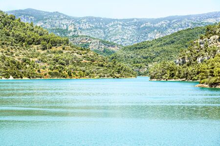 Turquoise lake and the mountains in forest. Beautiful landscapeの写真素材