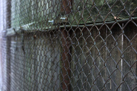 A wire fence and wooden fenceの写真素材