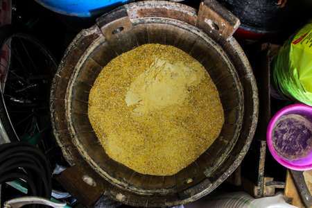 A wooden bucket filled with cornの写真素材