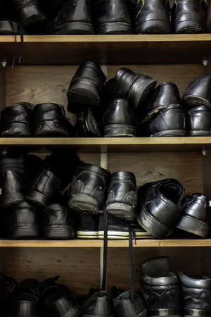 Shelves with some used and old footwearの写真素材