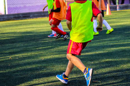 Kids on the green field play soccerの写真素材