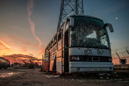 Rusty abandoned bus and sun riseの写真素材