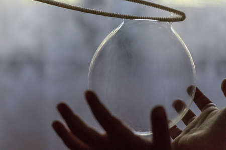 Kid hands on a soap balloon indoorの写真素材