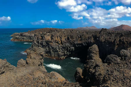 waves hitting on cliffの写真素材