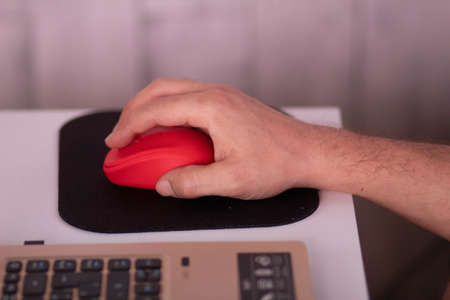 A man working on a laptop from home during COVID-19 quarantineの写真素材