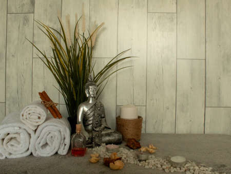 The spa essentials for aromatherapy near the silver statue of Buddhaの写真素材