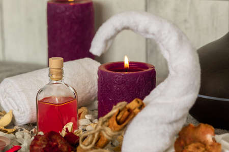 The natural oil and spa essentials near the candles for aromatherapyの写真素材